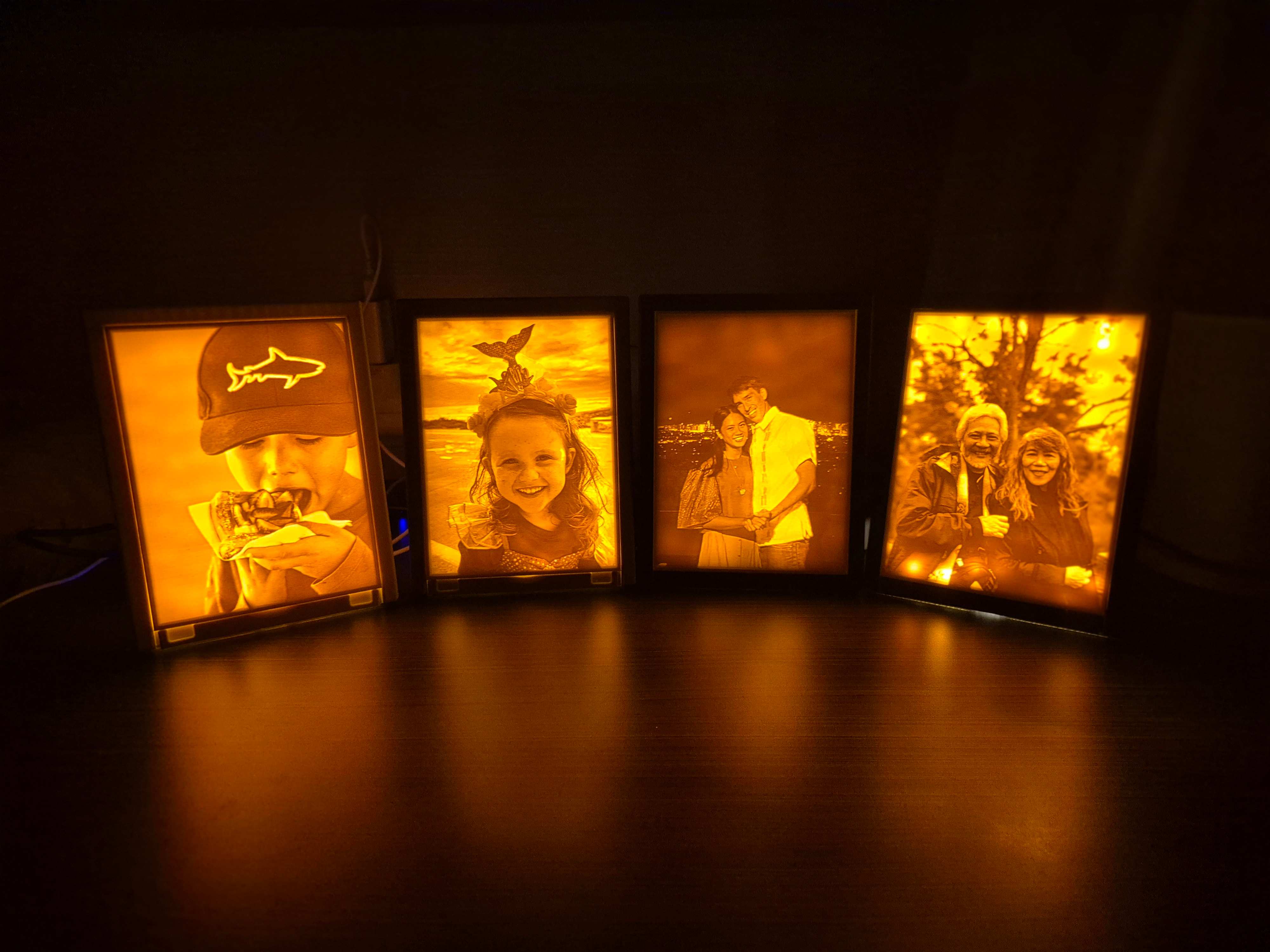 Four illuminated Lume lamps glowing warmly in the dark